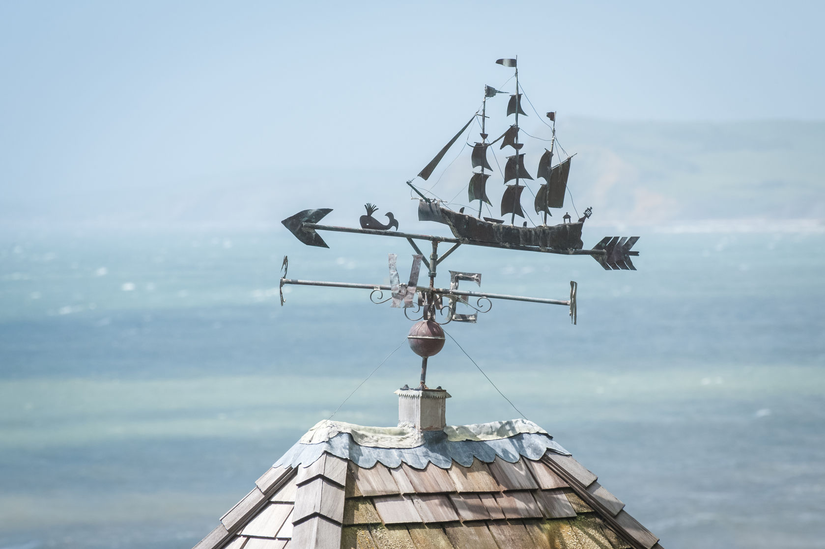 rooftop weathervane overlooking coastline