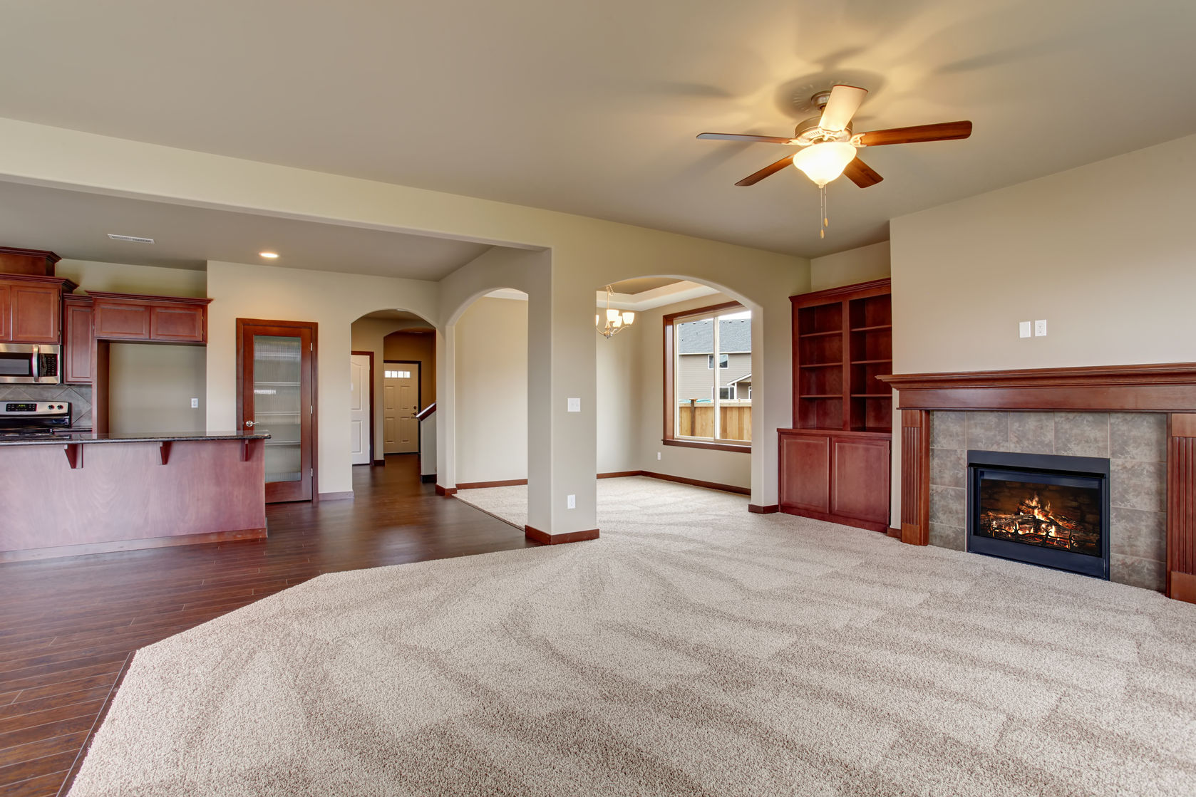 Unfurnished Living Room with Part Carpet and Wood Flooring | Photo